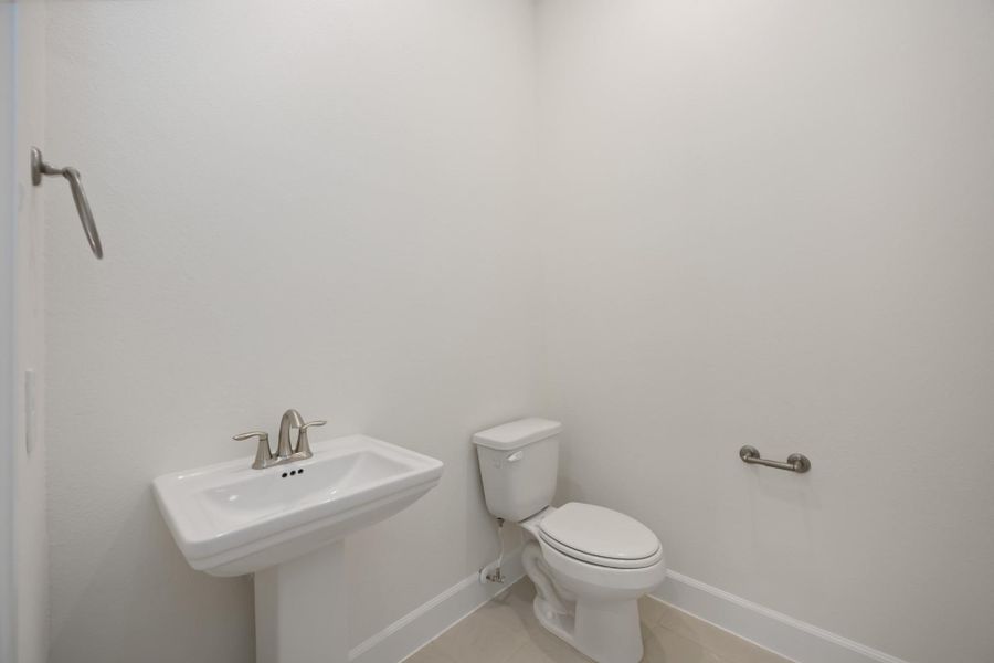 This powder bath may be petite, but it’s polished to perfection. With sleek fixtures and a splash of charm, it’s the kind of space guests will remember.