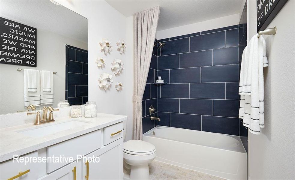 Bathroom featuring a white vanity with gold-tone hardware and a rectangular undermount sink