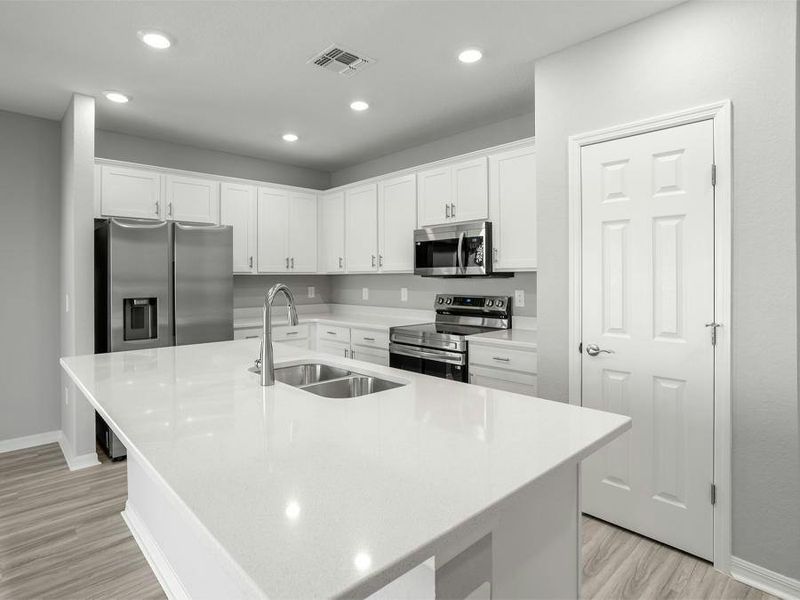 Your island kitchen includes 36-inch cabinets, quartz countertops, Samsung SS appliances, and a pantry.