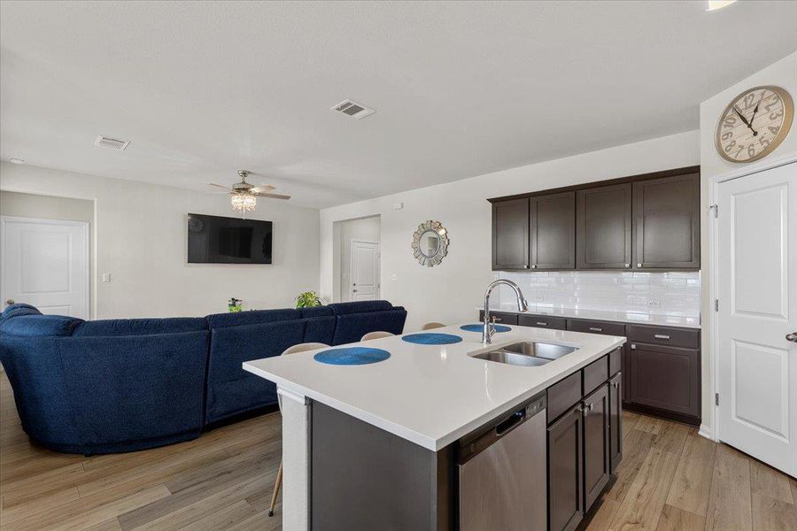 An open floor plan connects the kitchen island to the adjacent living area.