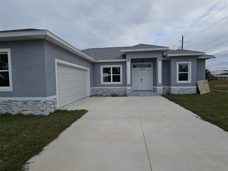 Front exterior of a new home in , Port Charlotte, FL, highlighting curb appeal (Image 11).