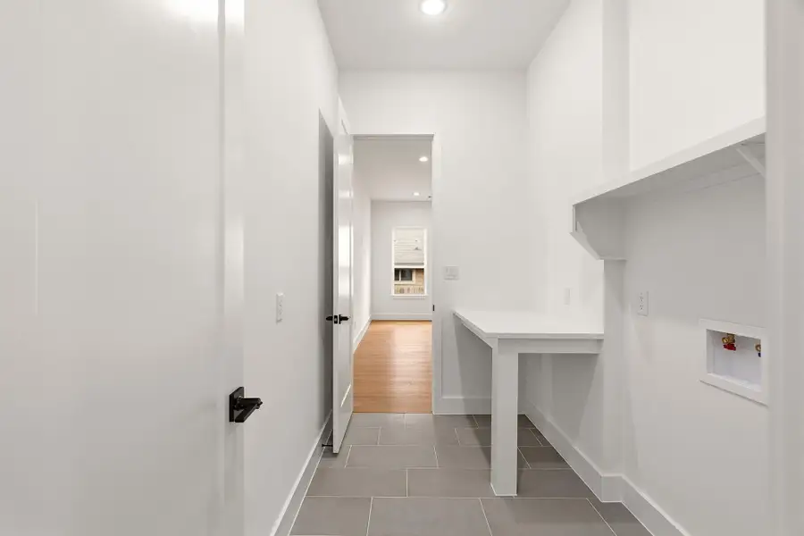 Laundry room with recessed lighting, light tile patterned flooring, and washer hookup