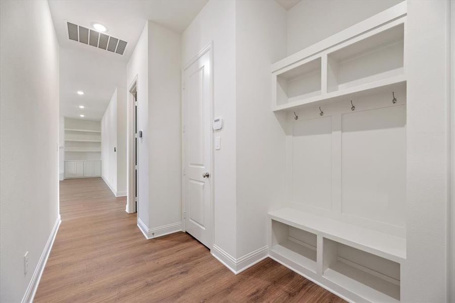 Mudroom with hardwood / wood-style flooring