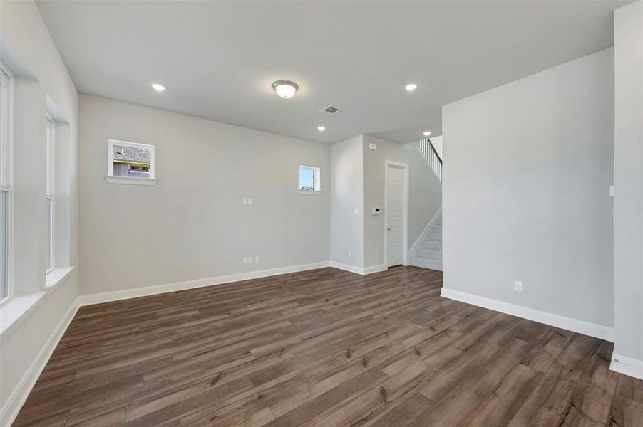 Spare room featuring dark wood finished floors, recessed lighting, and plenty of natural light