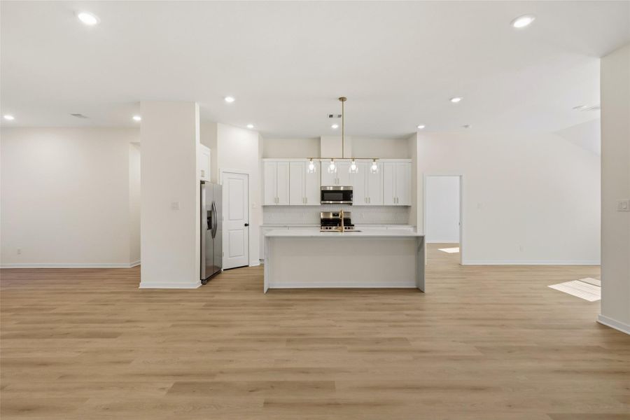 To the right lies the dining area and access to covered back patio.