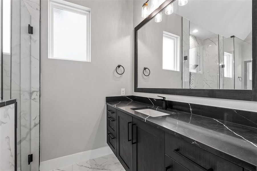 Bathroom featuring walk in shower, tile patterned floors, and vanity