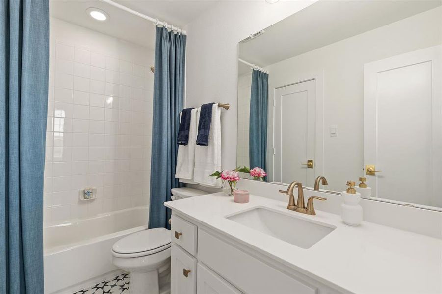 Bathroom with vanity, shower / bathtub combination with curtain, recessed lighting, and tile patterned floors Bathroom with vanity, shower / bathtub combination with curtain, recessed lighting, and tile patterned floors