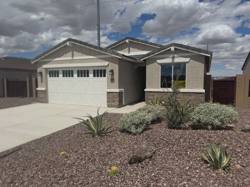 Front exterior of a new home in Camilo at Santana, Yuma, AZ, highlighting curb appeal (Image 2).