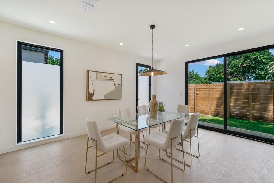 Dining room featuring light wood-style flooring and recessed lighting