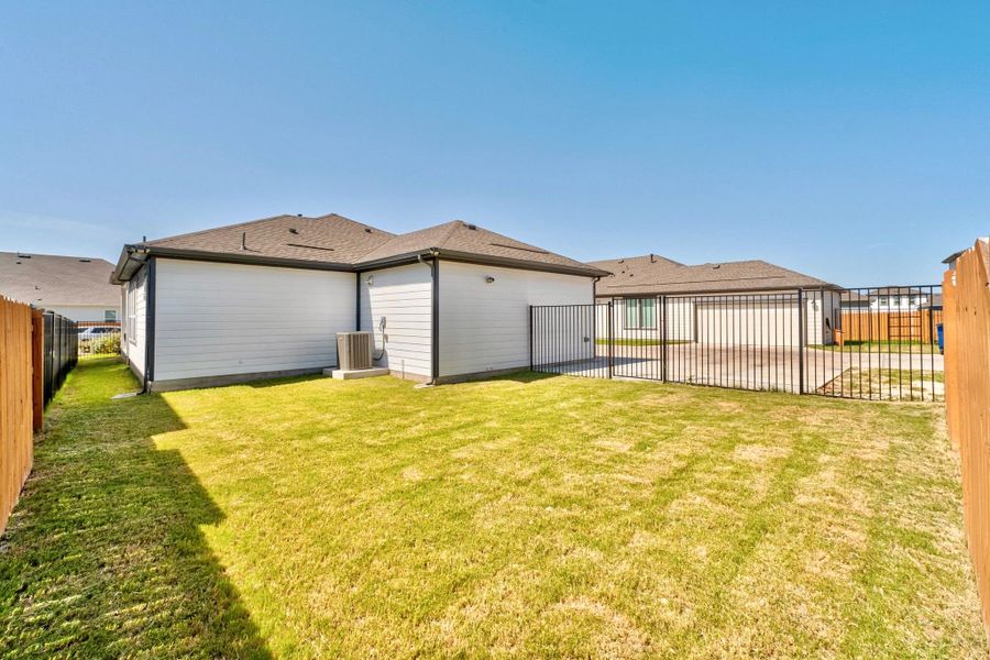 See the trail (left side) coming from the covered porch taking you to the side backyard with more green space than some of the other homes on the market.
