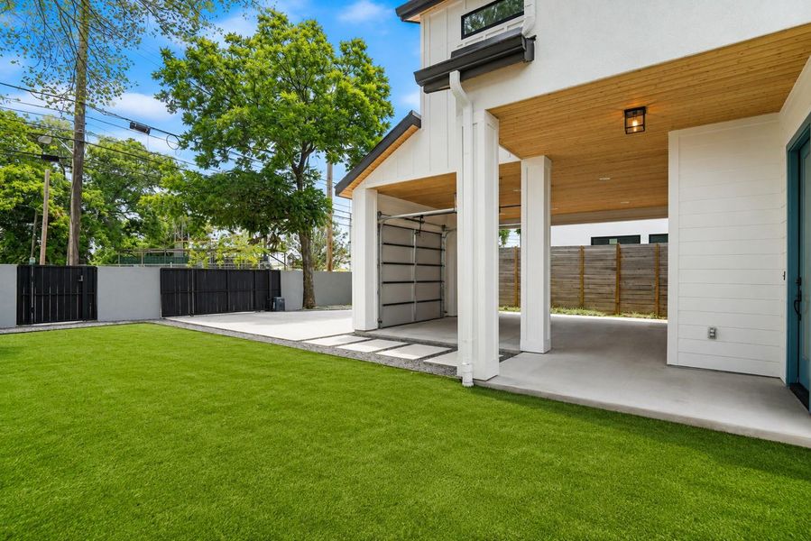 A pristine lawn stretches before a modern dwelling, offering ample parking and a welcoming entry.