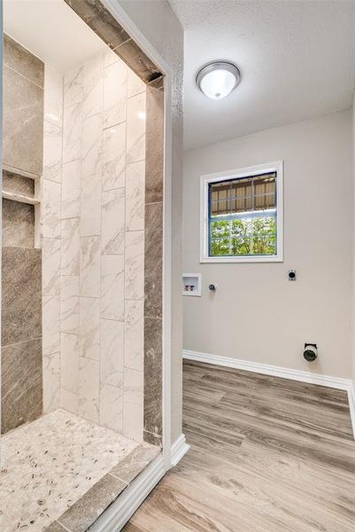 Bathroom with a shower stall and light wood finished floors Bathroom with a shower stall and light wood finished floors