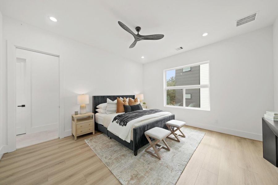 The owner's suite situated on the third level is complete with 10-foot ceilings, recessed lighting, ceiling fan, luxury vinyl flooring, an oversized window and is pre-wired for a flat screen TV.