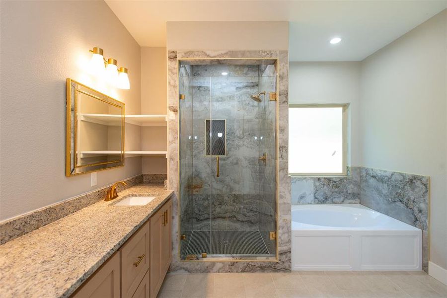 Bathroom with vanity, tile patterned floors, and separate shower and tub