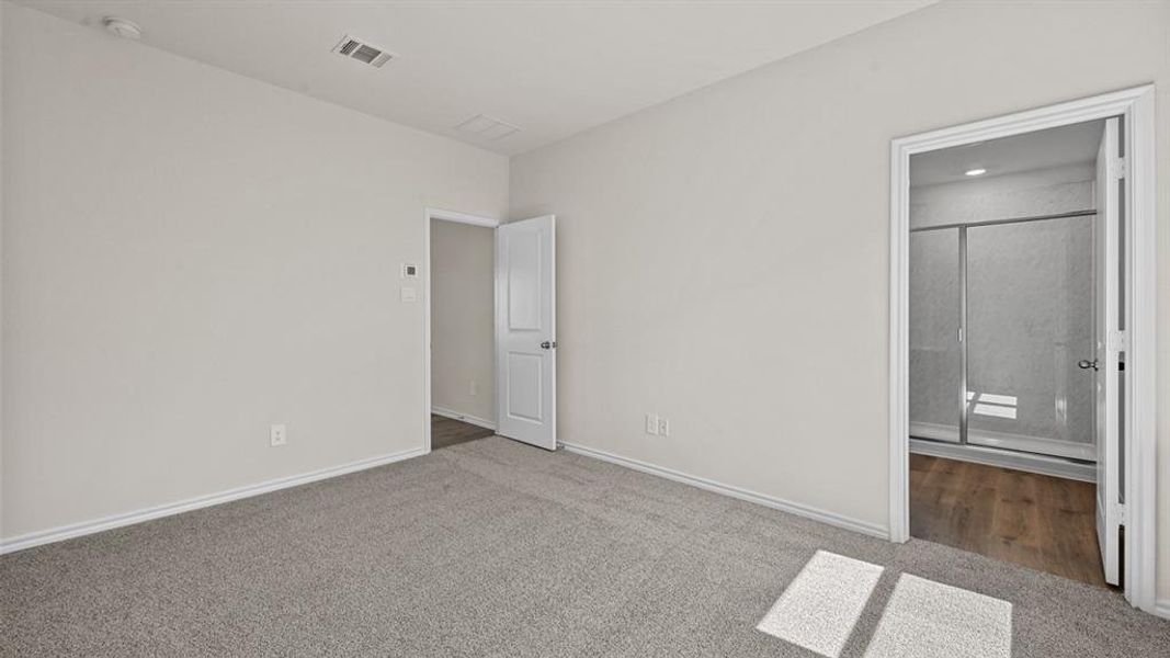 Spacious room featuring neutral carpeting and light-toned walls