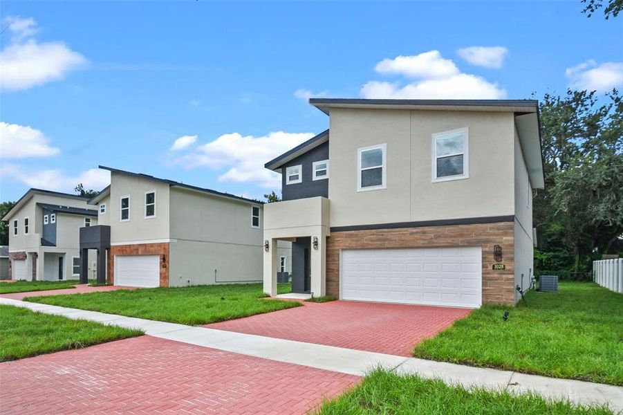 Front exterior of a new home in , Orlando, FL, highlighting curb appeal (Image 1). Front exterior of a new home in , Orlando, FL, highlighting curb appeal (Image 1).