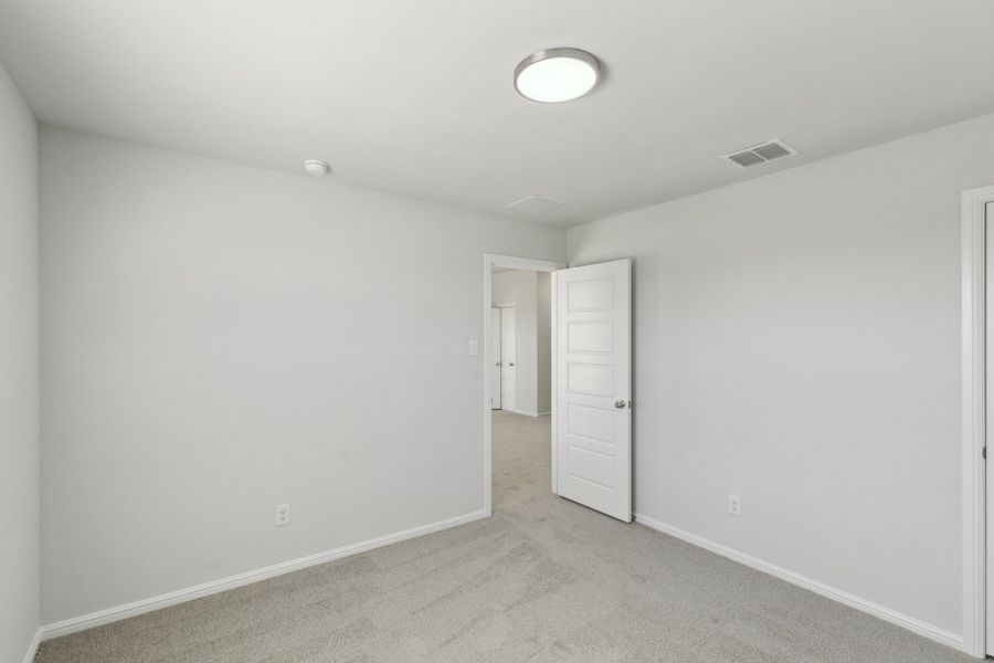 Bedroom in the Holden home plan by Trophy Signature Homes – REPRESENTATIVE PHOTO