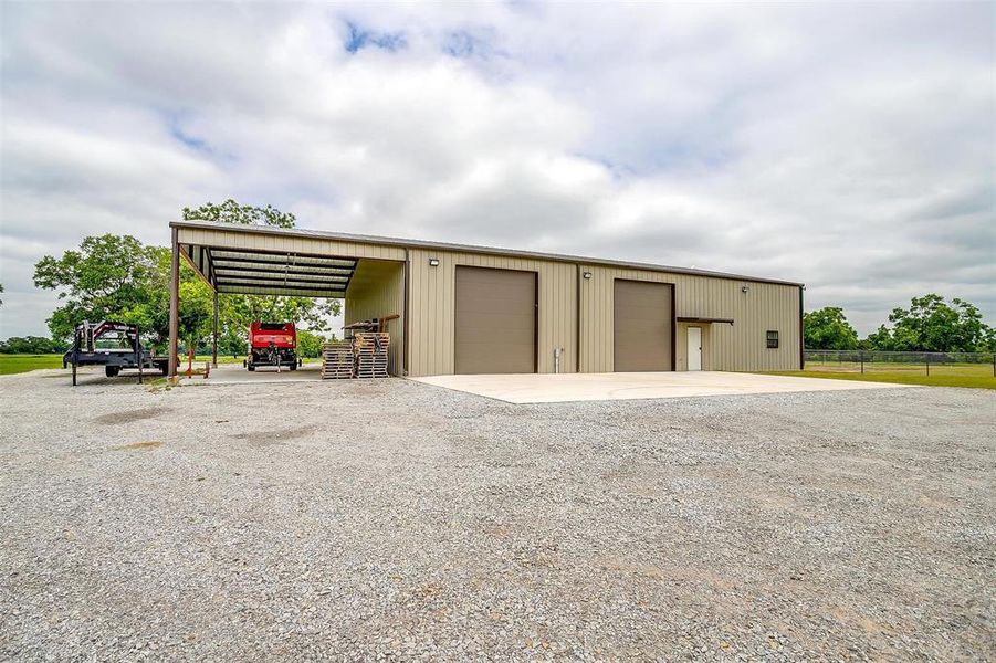 View of pole building featuring gravel driveway View of pole building featuring gravel driveway