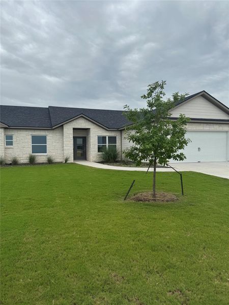 Front exterior of a new home in , Thorndale, TX, highlighting curb appeal (Image 1).