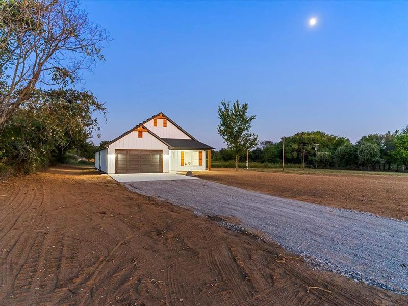 Modern farmhouse featuring driveway and a garage