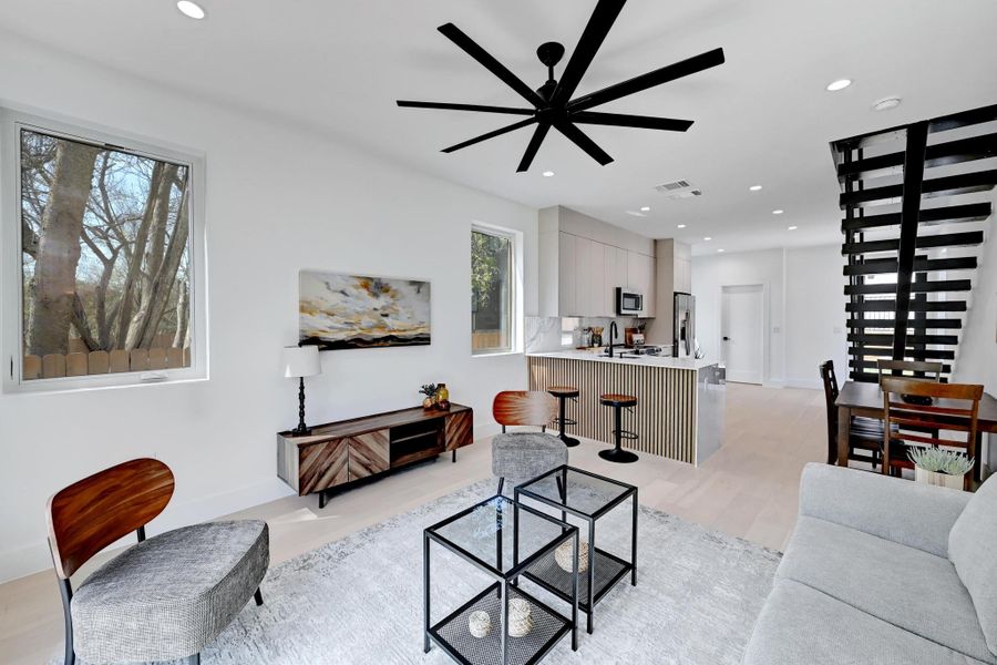 Living area featuring light wood finished floors, recessed lighting, and ceiling fan