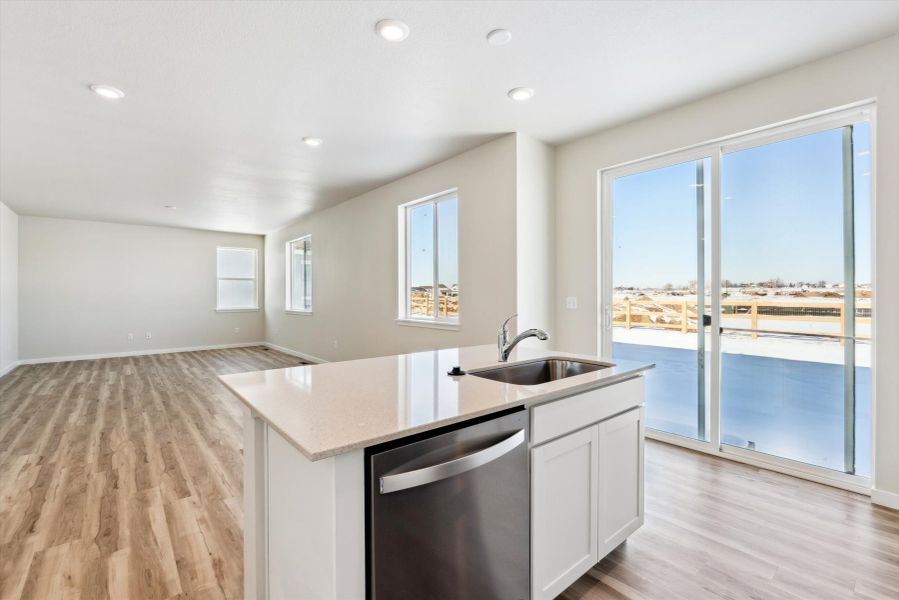 A kitchen with a large window.