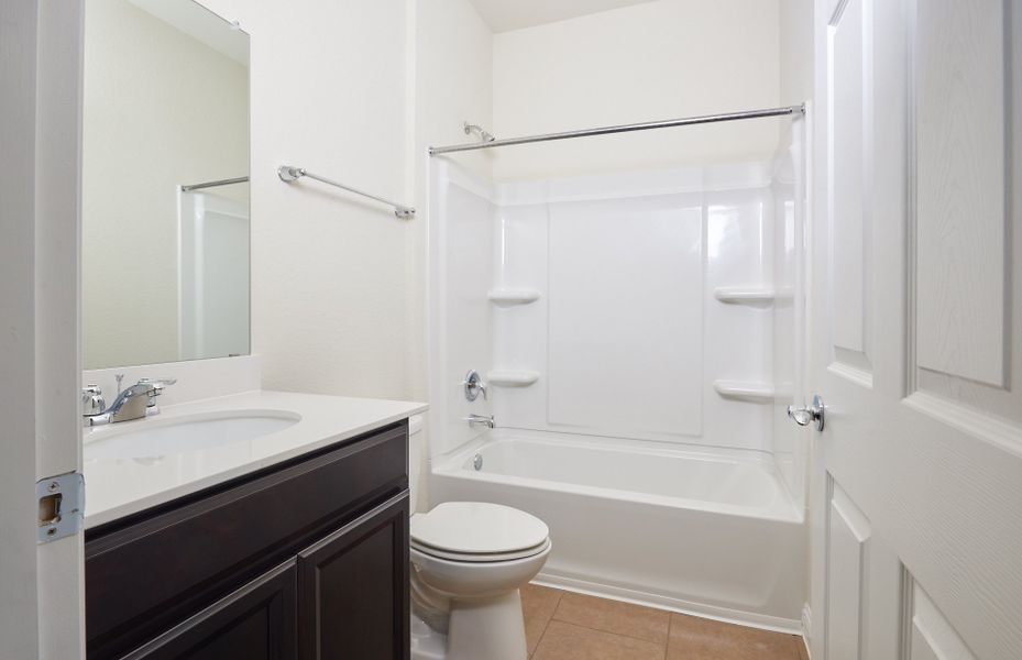 Secondary bathroom with tile flooring