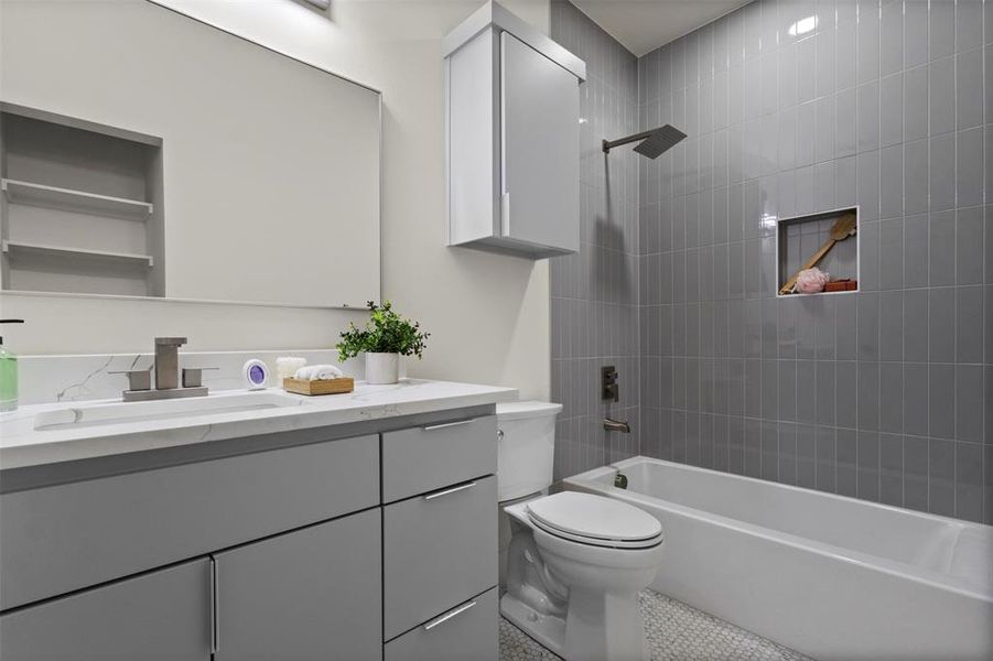 Full bath with shower / washtub combination, vanity, and light tile patterned floors