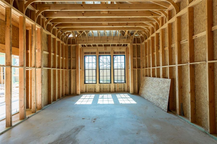The primary bedroom embodies soft sunlight filters through expansive windows, hinting at a beautifully balanced room where openness and quiet comfort will come together effortlessly.