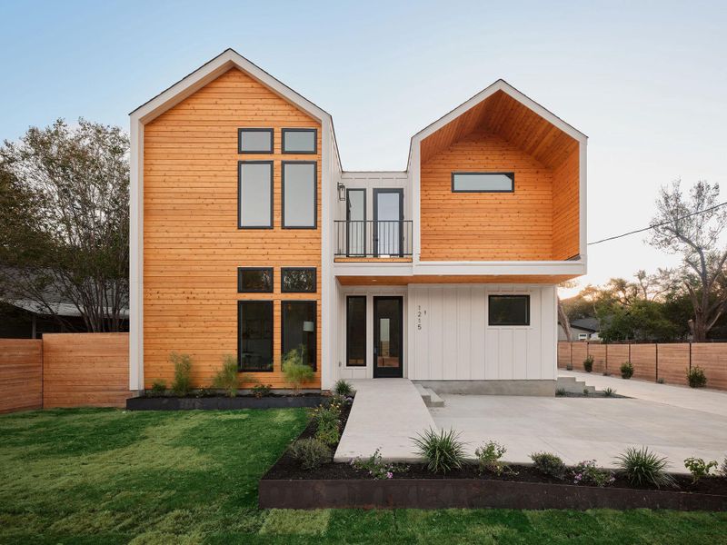 Back of house with a balcony and a fenced backyard Back of house with a balcony and a fenced backyard