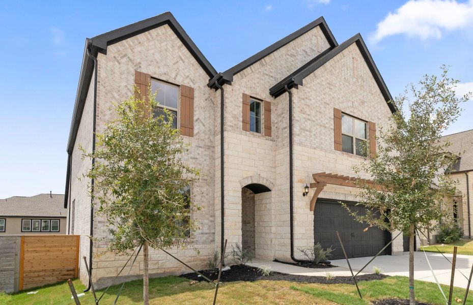 Front exterior of a new home in Bluffview Reserve, Leander, TX, highlighting curb appeal (Image 21).