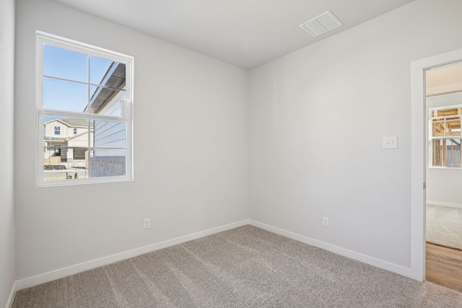 A room with a window and a carpet. A room with a window and a carpet.