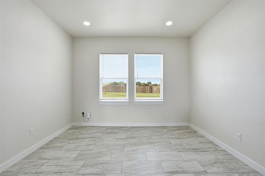 Neutral-toned interior room featuring tile flooring, white baseboards, and light-colored walls
