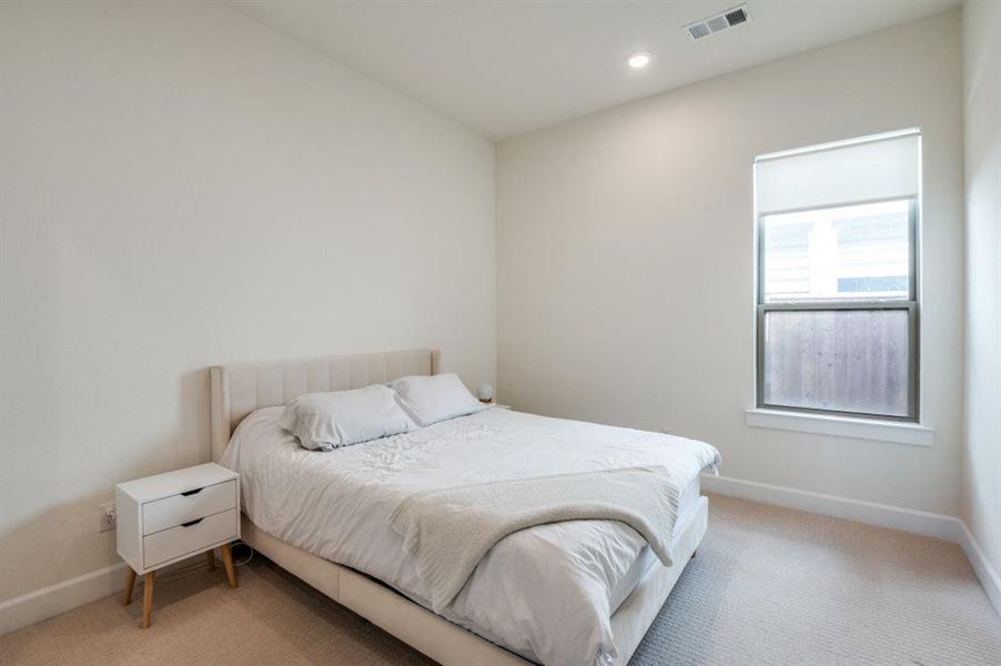 Carpeted bedroom featuring baseboards and recessed lighting Carpeted bedroom featuring baseboards and recessed lighting