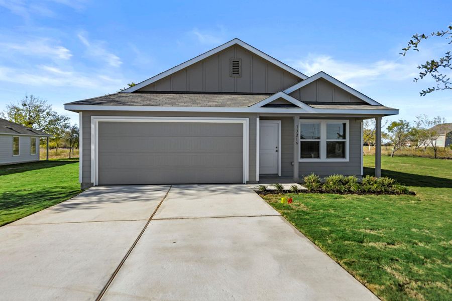 View of front of home featuring board and batten siding, a front lawn, driveway, and a garage View of front of home featuring board and batten siding, a front lawn, driveway, and a garage