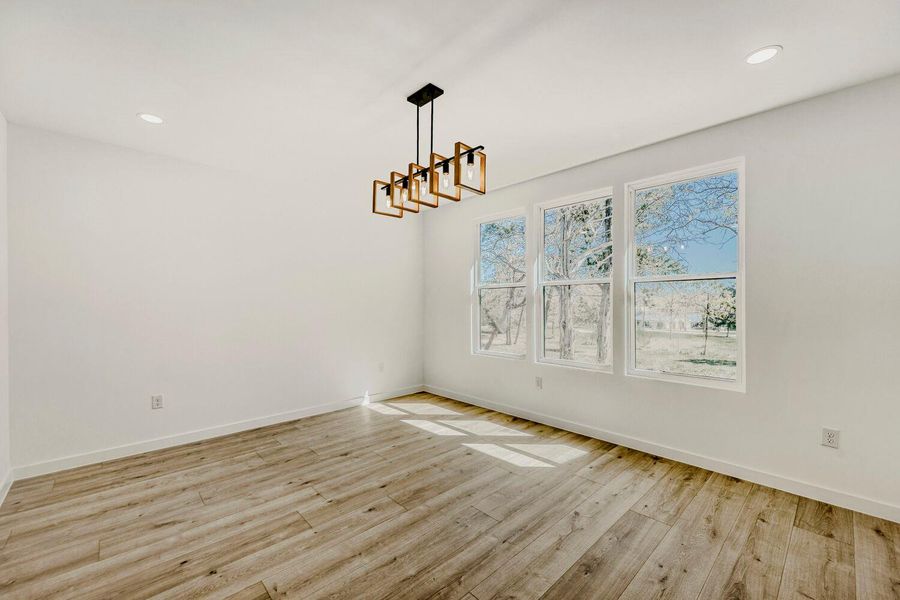 Unfurnished dining area featuring recessed lighting and light wood-style flooring