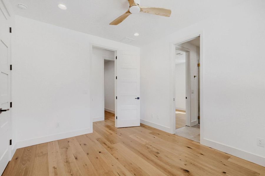 Unfurnished bedroom featuring light wood-style flooring, ceiling fan, and recessed lighting Unfurnished bedroom featuring light wood-style flooring, ceiling fan, and recessed lighting
