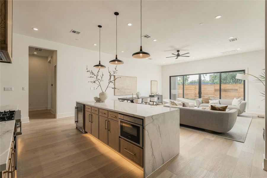 Designed for connection, the kitchen opens effortlessly into the main living area, with the expansive island creating a natural gathering place at the heart of the home.