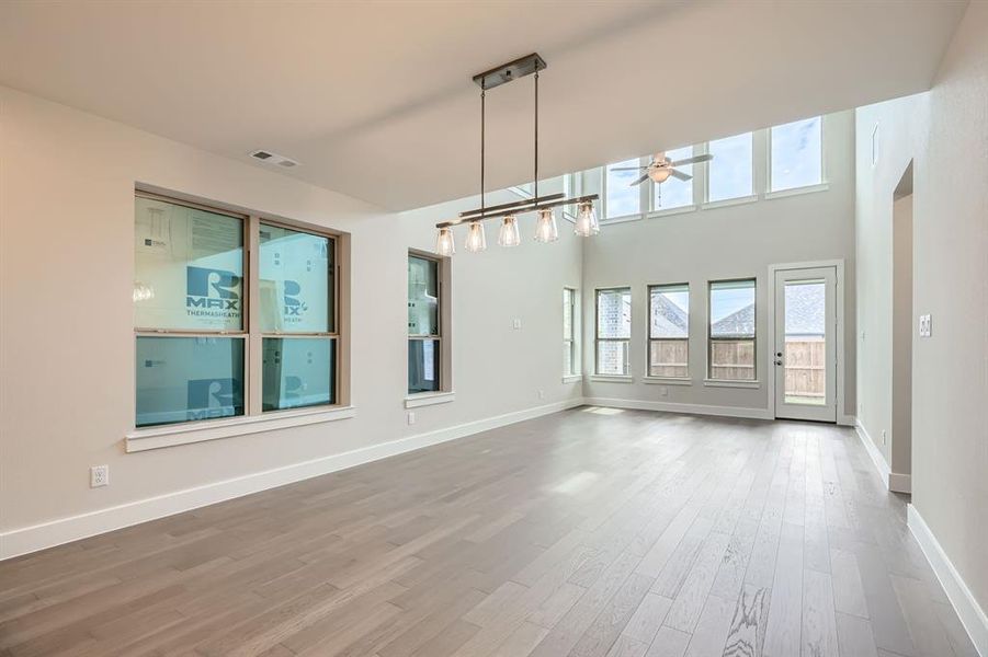 Unfurnished living room with a ceiling fan and wood finished floors
