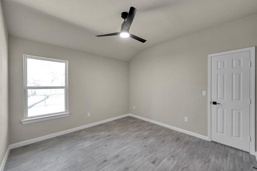 Wake up to tranquil views in this sun-drenched bedroom. The neutral "greige" walls and crisp white trim provide a sophisticated backdrop for any decor style.