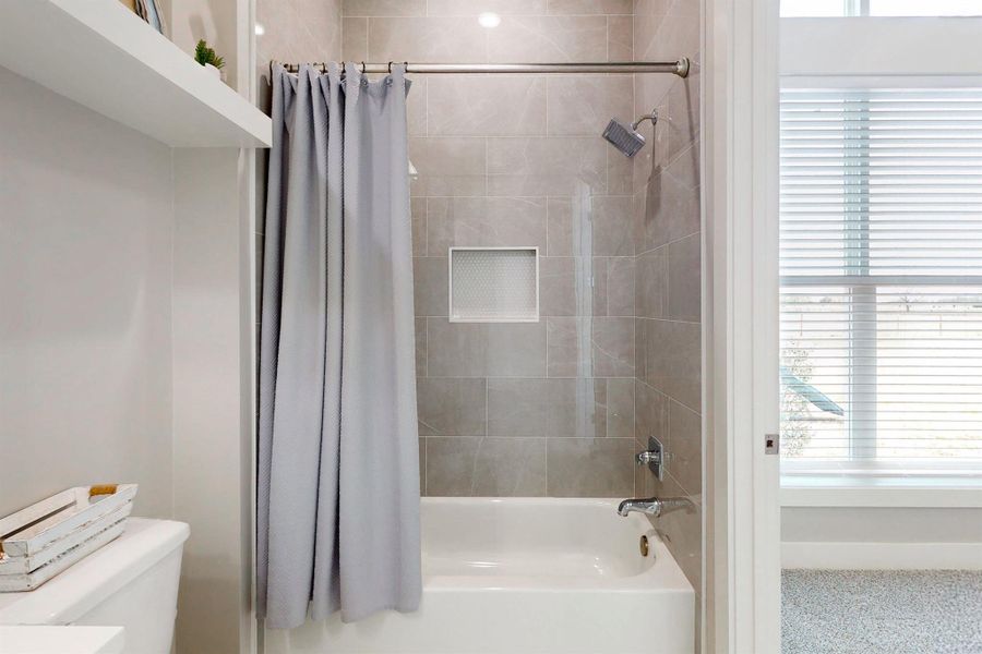 Each tub or shower area is tiled all the way to the ceiling. Floors are tiled in all wet areas