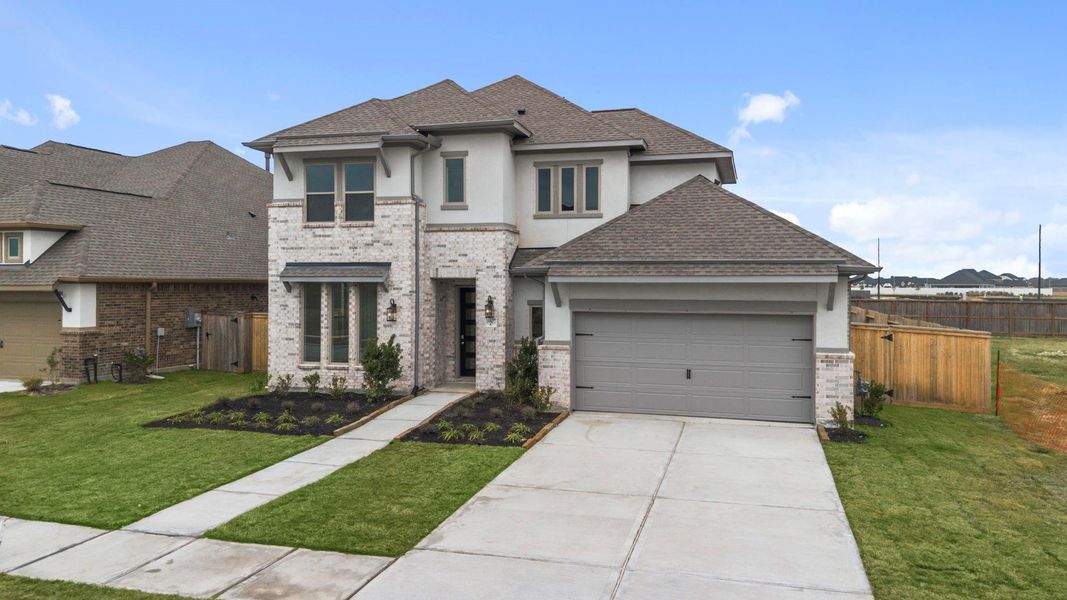 Front exterior of a new home in Valencia, Manvel, TX, highlighting curb appeal (Image 20).