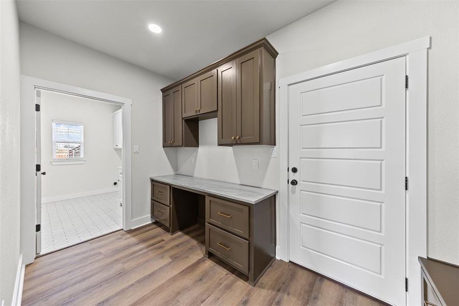 Mud Room with built in study area, dark wood-style flooring, and recessed lighting Mud Room with built in study area, dark wood-style flooring, and recessed lighting