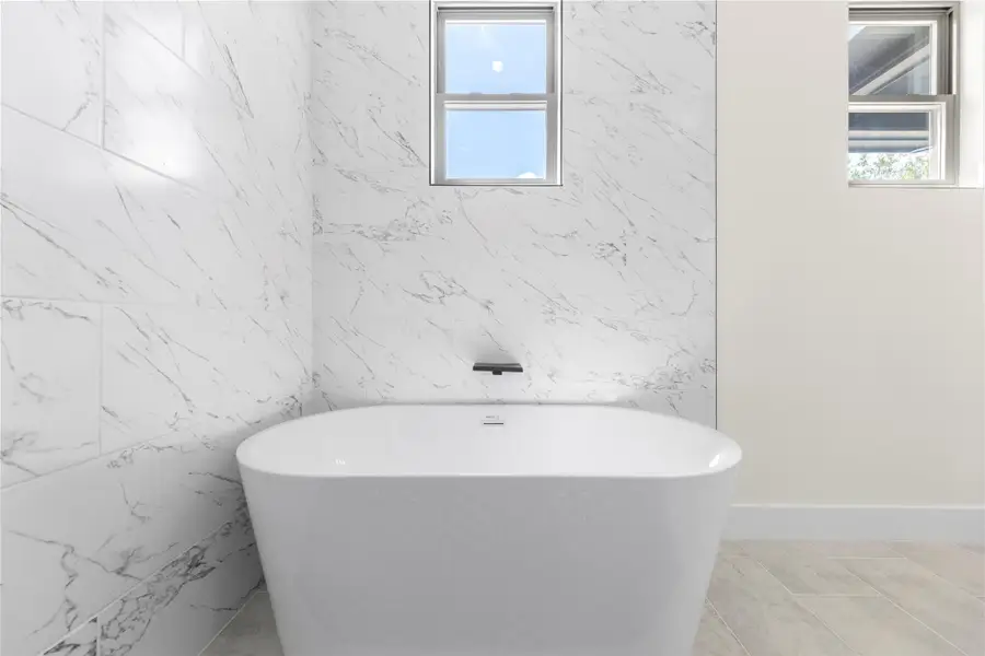 Bathroom with a soaking tub and tile walls Bathroom with a soaking tub and tile walls