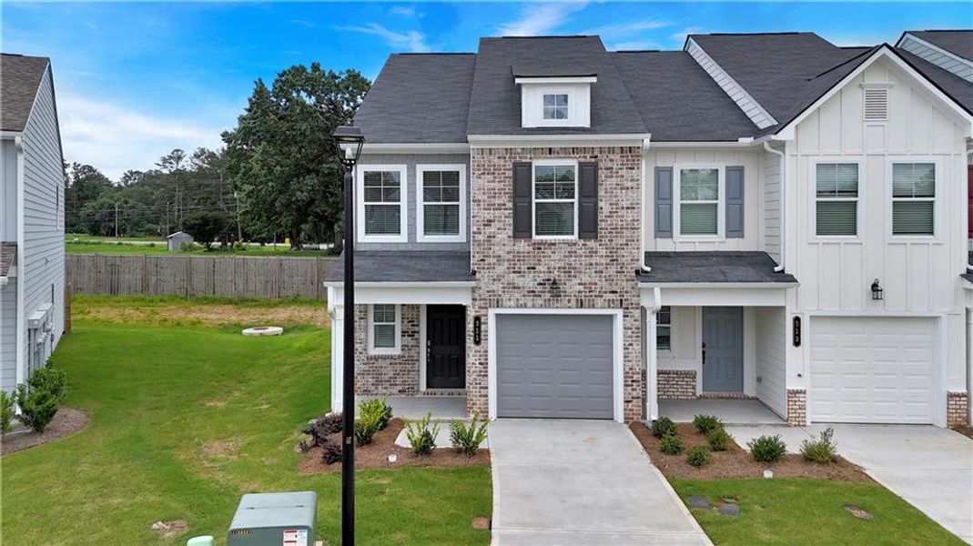 Front exterior of a new home in Village Green, Adairsville, GA, highlighting curb appeal (Image 25).