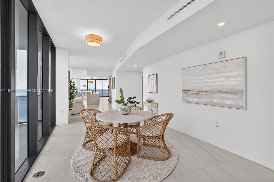 Open dining area with floor to ceiling glass, adjacent to chef’s kitchen and terrace for seamless indoor outdoor entertaining. This area is also a possible den / 4th bedroom as per the builders plans. Unit is a 4 bedroom per tax roll