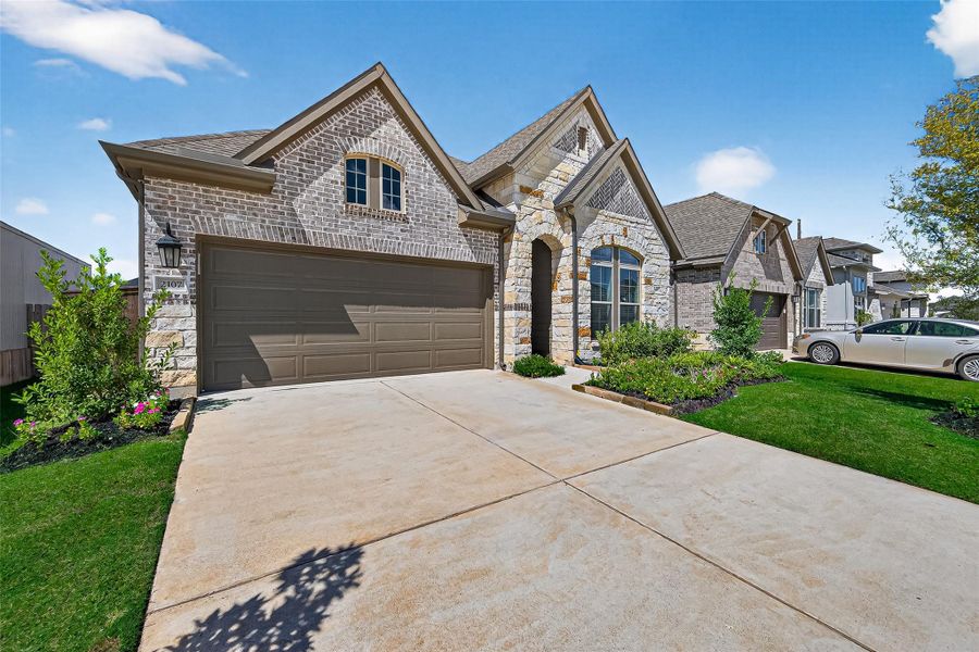 Front exterior of a new home in Harvest Green 45', Richmond, TX, highlighting curb appeal (Image 25).