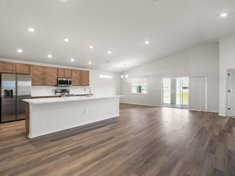 The spacious, open living area is finished with low-maintenance luxury vinyl plank flooring.