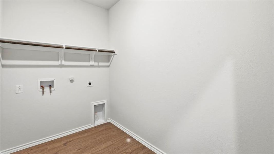 Laundry room featuring gas dryer hookup, dark wood-style flooring, hookup for a washing machine, and hookup for an electric dryer