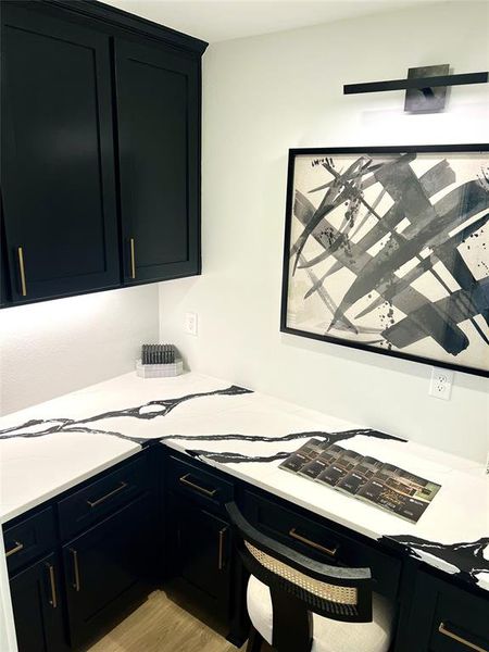 Kitchen with dark cabinetry and light countertops Kitchen with dark cabinetry and light countertops